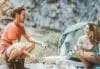 Trekker couple camping in rock mountains with a tent