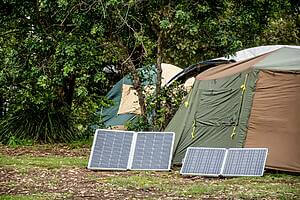 camping with solar panels portable foldable solar panels near the tent | Camping Check