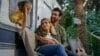 Caucasian family in camping outdoors little funny 10s girl daughter child looking out window of van