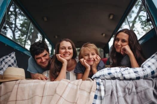 Happy family portrait in camping trailer