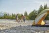 Rear view of family playing in river by tent, Wallgau, Bavaria, Germany