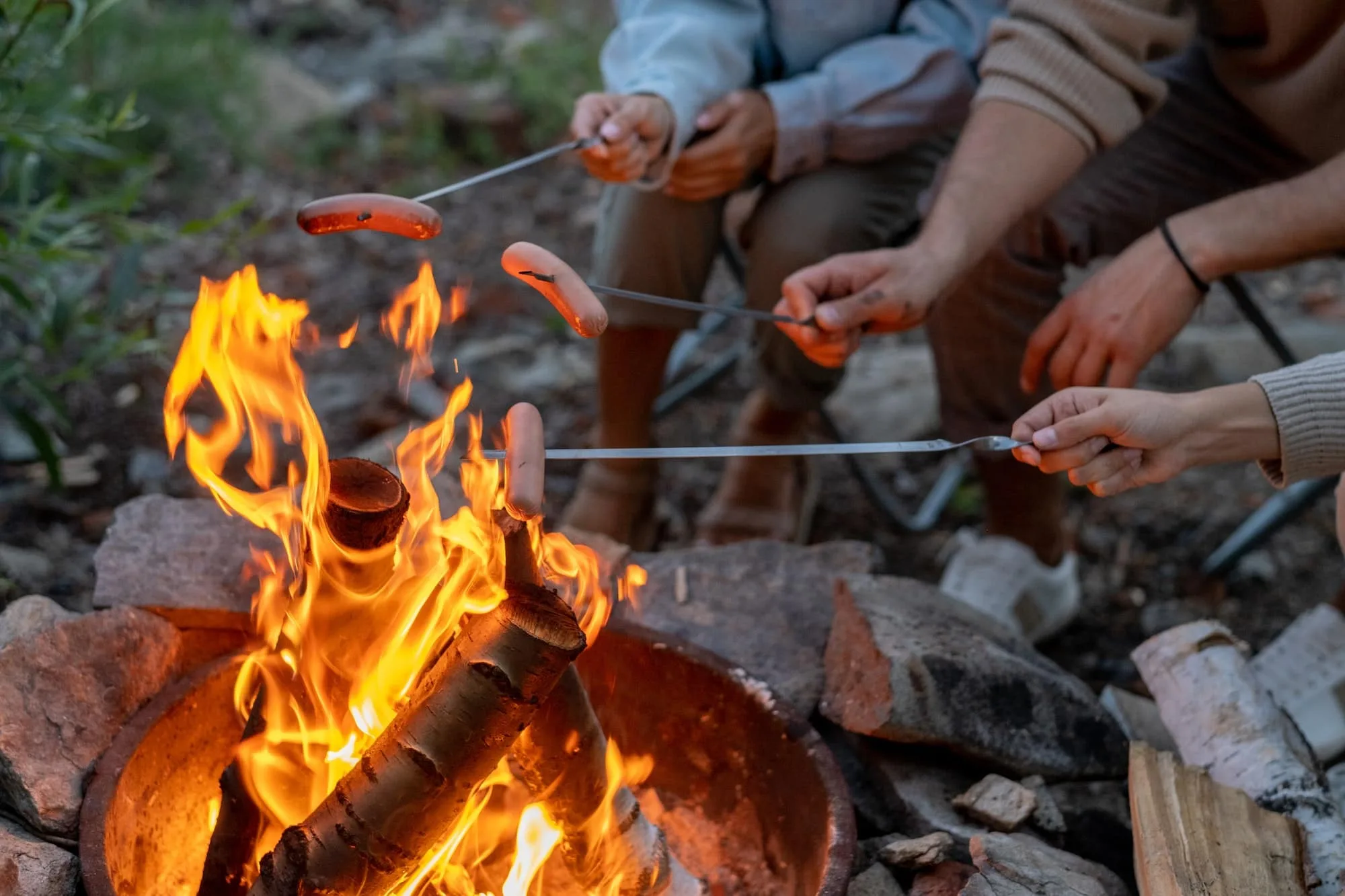 Campingabenteuer pur: Ihr ultimativer Guide für einen unvergesslichen Campingurlaub 4 Young family of three cooking sausages over campfire