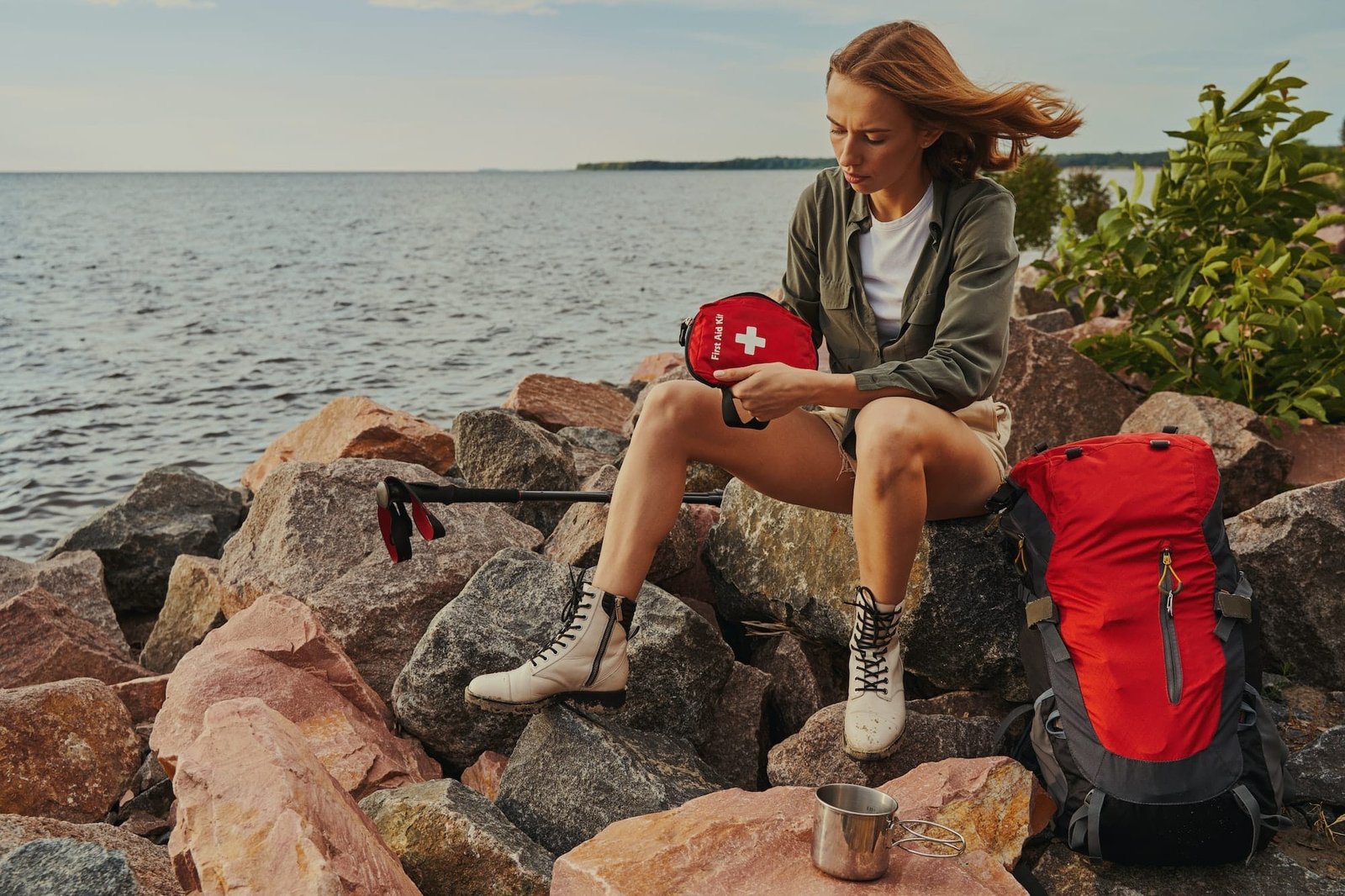 Backpacker getting medicine out of first aid kit