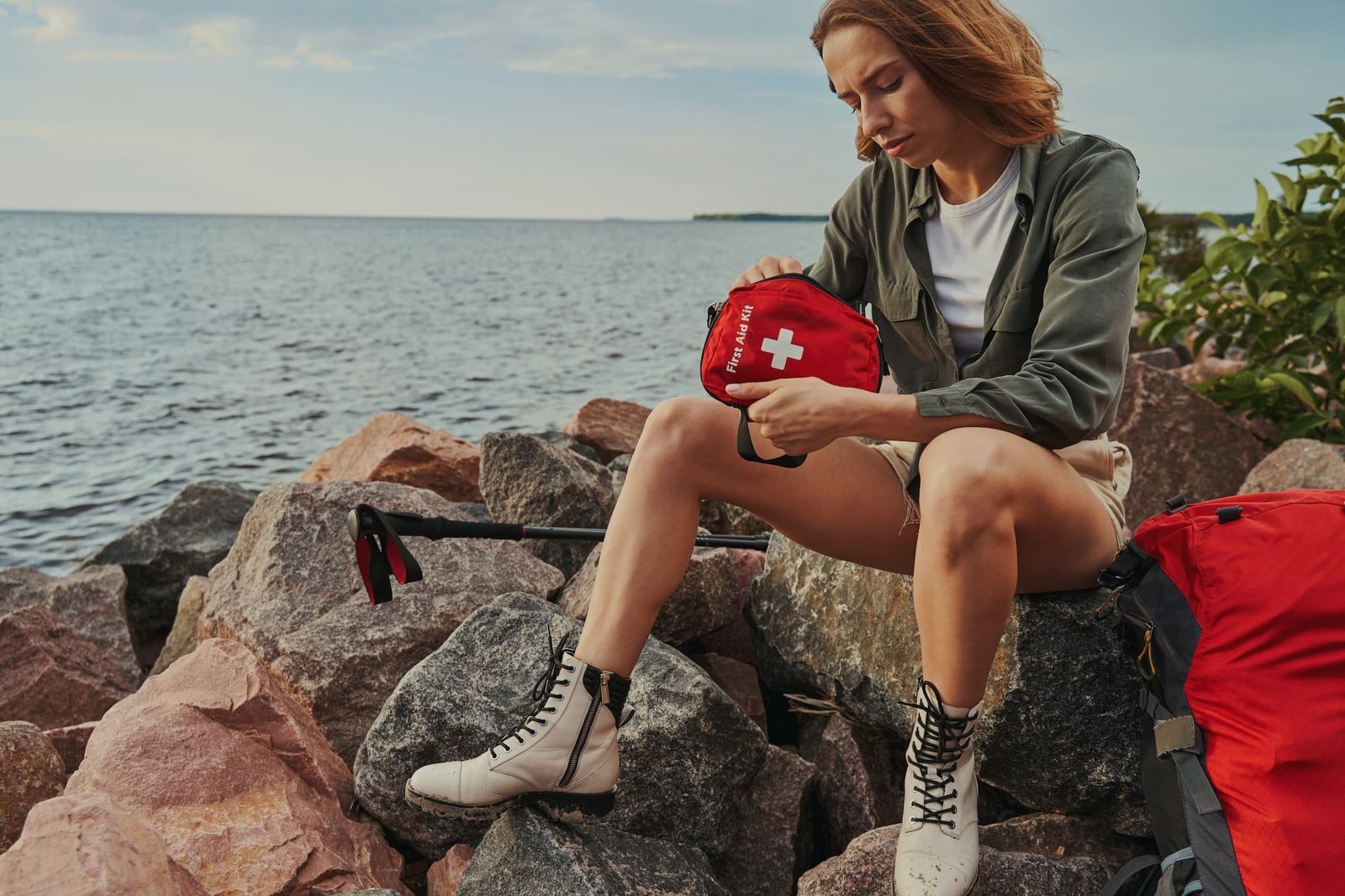 Fit female reaching inside first aid kit