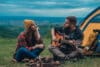Couple of campers playing guitar and camping in the nature