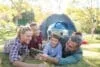 Family taking a selfie outside the tent