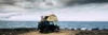 Banner travel header with man sitting on the roof of the car with camping tent having relax