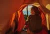Hiker in tent turned back to camera