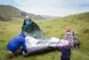 family gathers tent in mountains on hike. outdoor activities for children and elderly