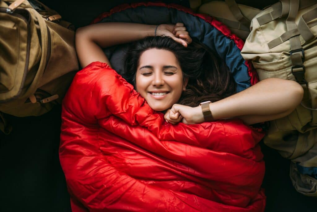 The traveler is resting in a sleeping bag. Rest concept. A tourist is resting in a tent.