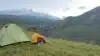 traveller and tent in mountaines