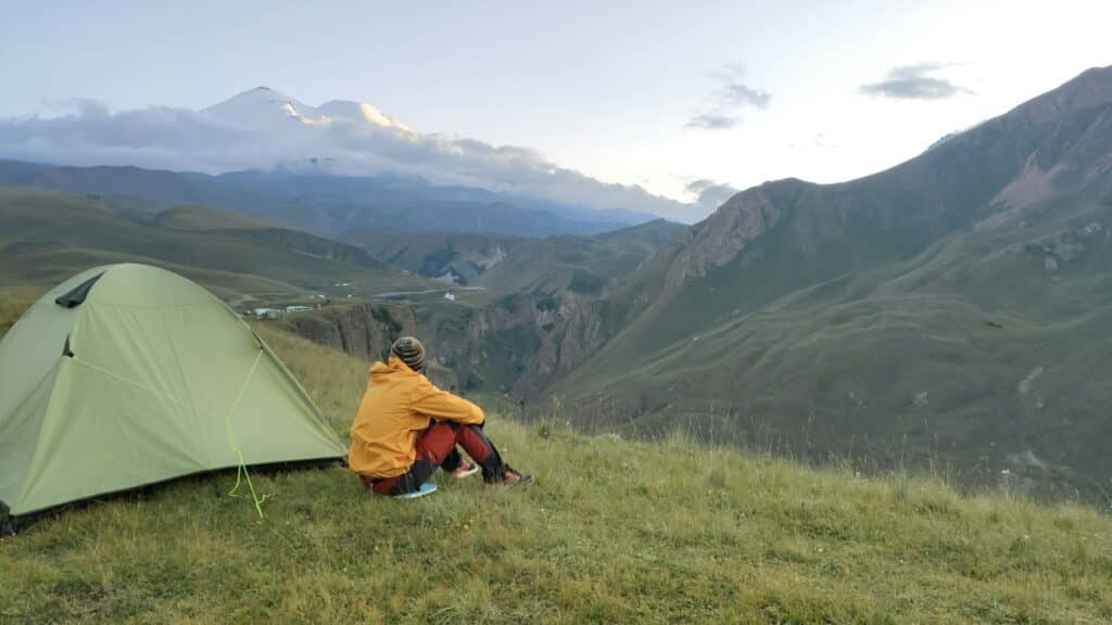 traveller and tent in mountaines