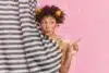 Lovely African American woman keeps lips folded takes morning shower in bathroom undergoes self care