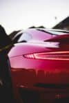 Back view of red Porsche in street