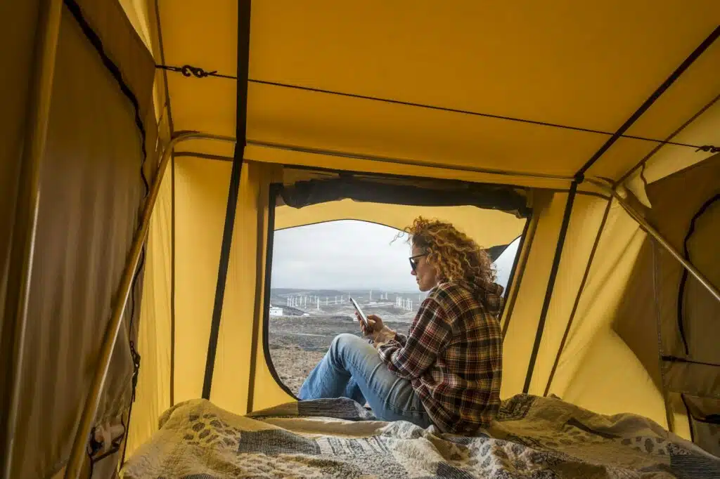 beautiful caucasian woman enjoy camping on tent