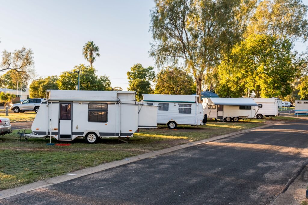Various RV caravans camping on campsites at the caravan holiday park.