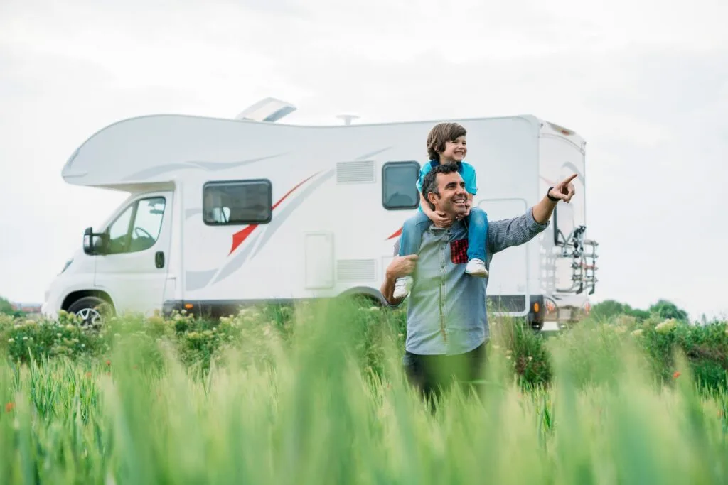 Father and son with the holiday caravan