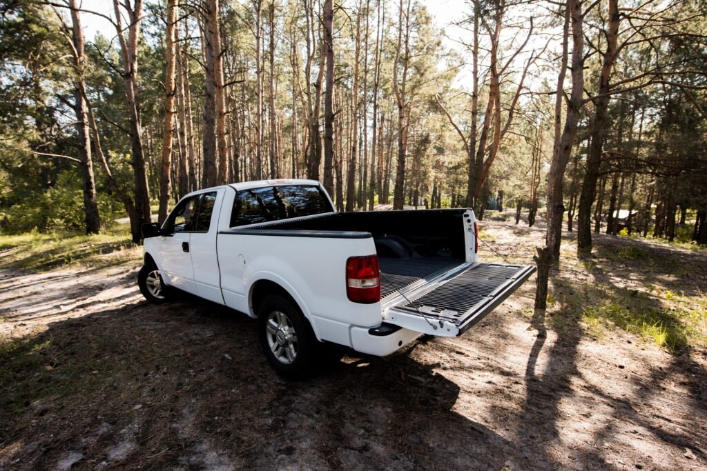 white pickup car with opened truck in forest