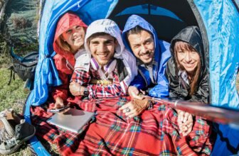 Best friends couples taking selfie at camping tent on sunny day after the rain
