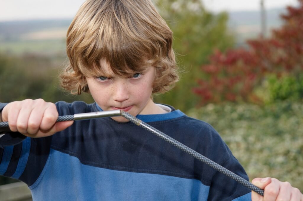 Boy erecting tent poles